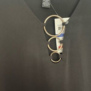 Black knit shirt with gold rings at the top